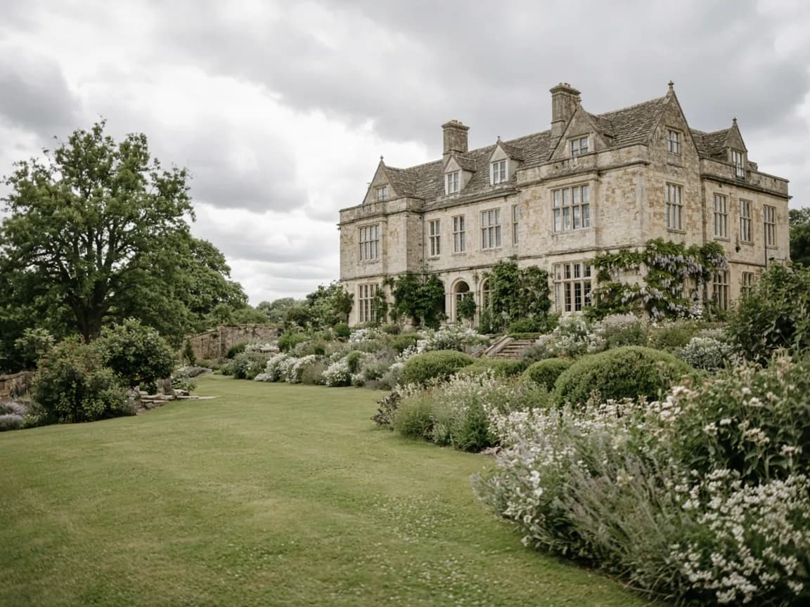 Soft British countryside lawn leading to a stone country house